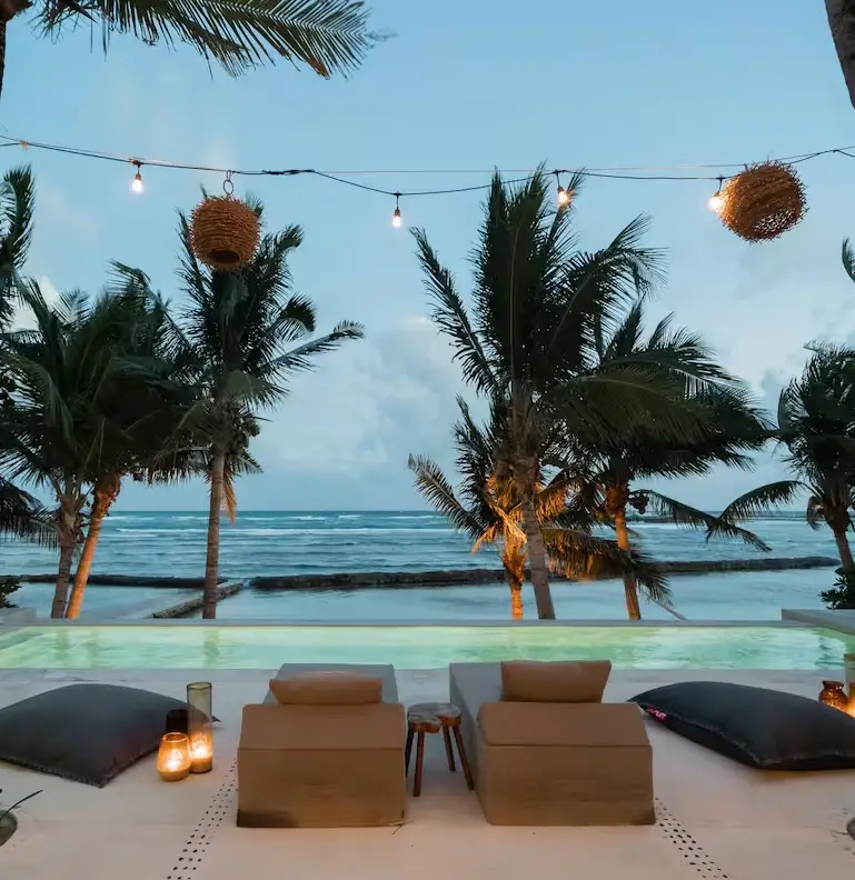 Loungers facing the Caribbean under the palms