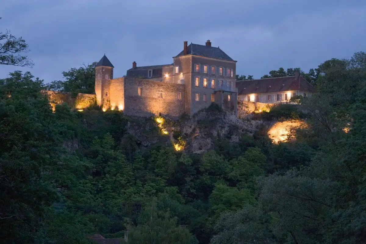 Château des Siècles lit at night above the Burgundy countryside